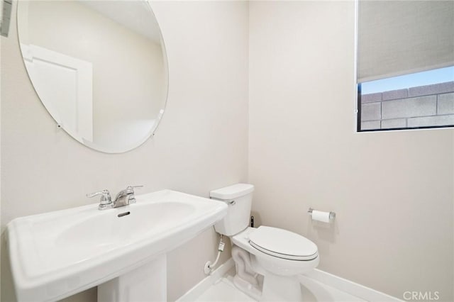 16773 Grapefruit Ln, Fontana, CA 92336 - half bathroom featuring baseboards and toilet
