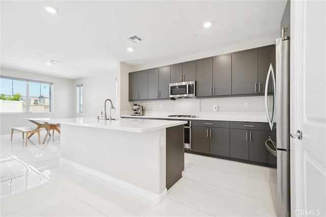 16773 Grapefruit Ln, Fontana, CA 92336 - kitchen featuring appliances with stainless steel finishes, a sink, light countertops, light tile patterned floors, and recessed lighting