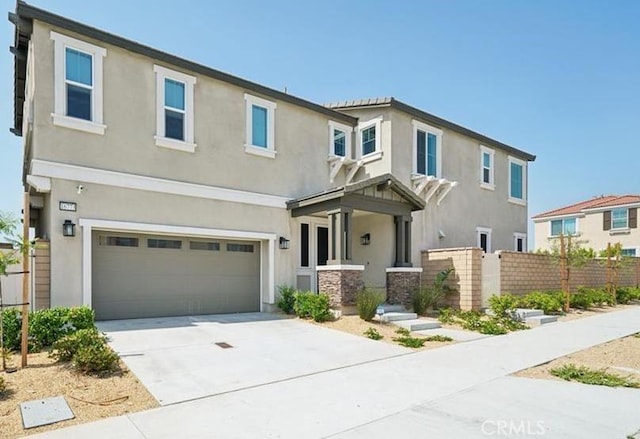 16773 Grapefruit Ln, Fontana, CA 92336 - view of front of property featuring stucco siding, a garage, and driveway