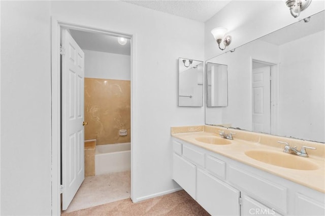 30369 Colina Verde St, Temecula, CA 92592 - bathroom with double vanity, a bathtub, a textured ceiling, and baseboards