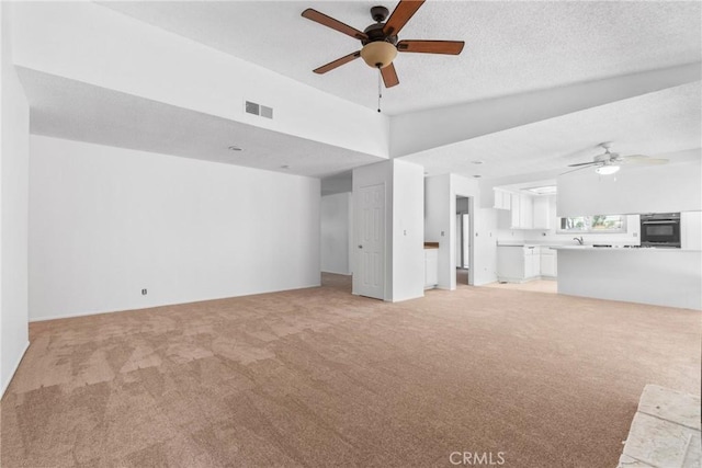 30369 Colina Verde St, Temecula, CA 92592 - unfurnished living room featuring ceiling fan, light carpet, vaulted ceiling, and a sink