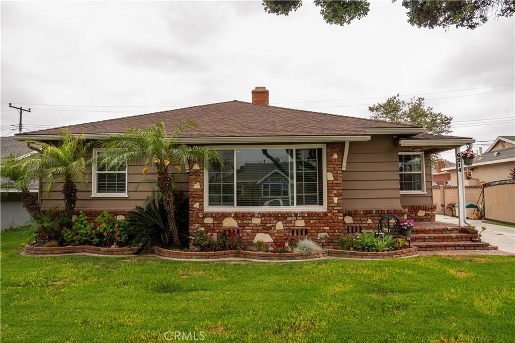 6214 Hungerford St, Lakewood, CA 90713 - view of front facade with a chimney, a patio area, and a shingled roof