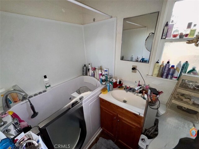 21835 Dotame Ave, Apple Valley, CA 92307 - full bathroom with vanity, a tub, and healthy amount of natural light