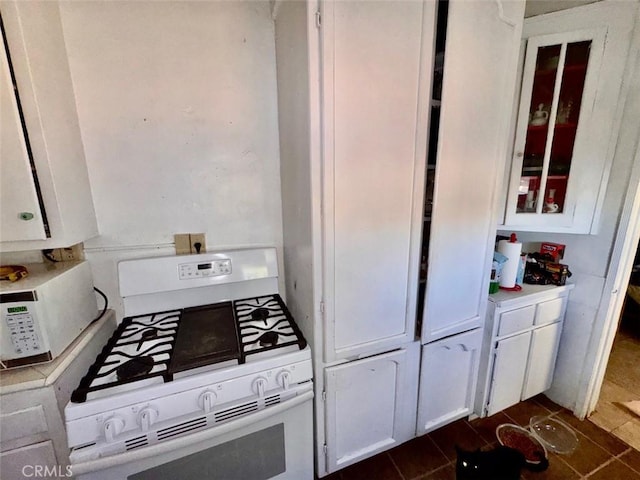 21835 Dotame Ave, Apple Valley, CA 92307 - kitchen with white appliances, white cabinetry, glass insert cabinets, and light countertops