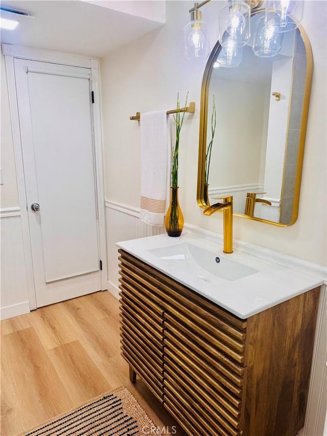 5322 Briercrest Ave, Lakewood, CA 90713 - bathroom view of vanity, wood finished floors, arched walkways, and a wainscoted wall