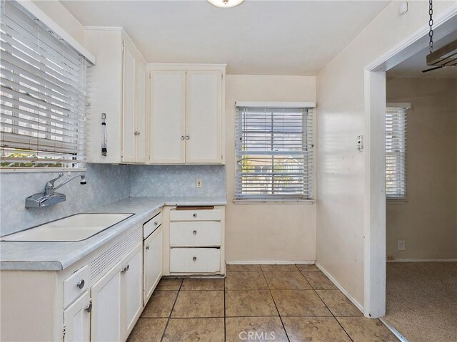 517 N Avon St, Burbank, CA 91505 - kitchen featuring a sink, light countertops, white cabinetry, tasteful backsplash, and light tile patterned flooring