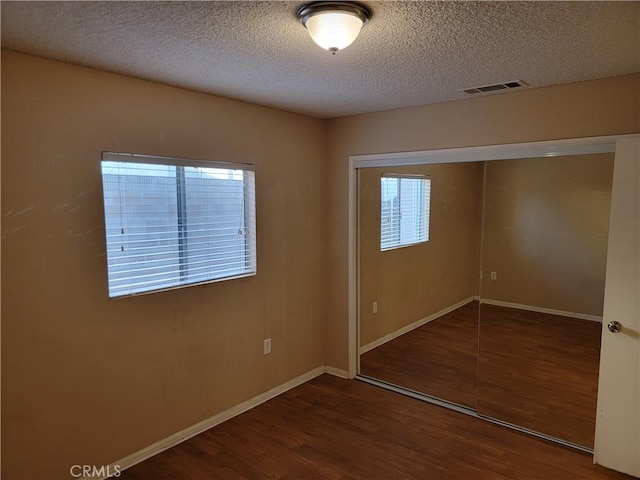733 Piccadilly, Hemet, CA 92544 - unfurnished bedroom featuring wood finished floors, a textured ceiling, a closet, and baseboards