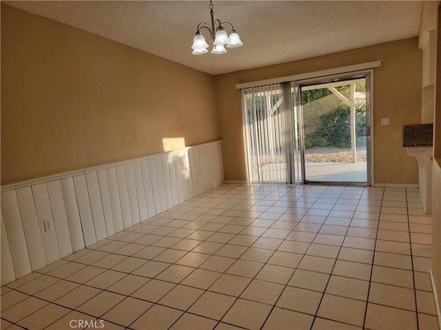 733 Piccadilly, Hemet, CA 92544 - unfurnished room featuring a chandelier, a textured ceiling, and light tile patterned floors
