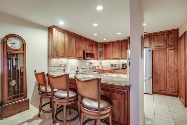2209 W 25th St Unit 2, San Pedro, CA 90732 - kitchen featuring appliances with stainless steel finishes, light stone counters, recessed lighting, decorative backsplash, and glass insert cabinets