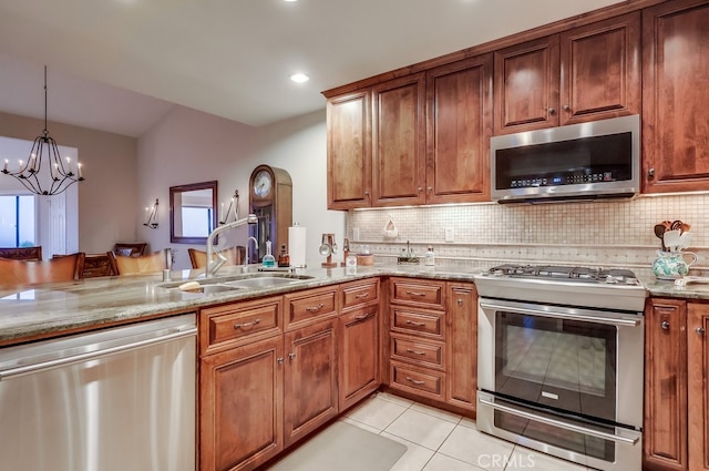 2209 W 25th St Unit 2, San Pedro, CA 90732 - kitchen featuring appliances with stainless steel finishes, light stone counters, decorative backsplash, brown cabinetry, and recessed lighting