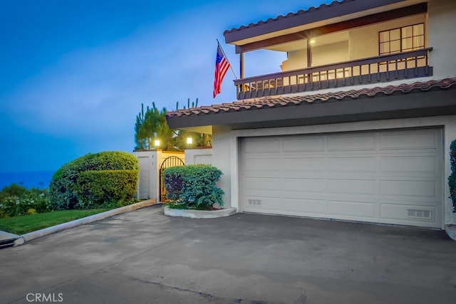 2209 W 25th St Unit 2, San Pedro, CA 90732 - view of front of home featuring a balcony, a tile roof, stucco siding, and asphalt driveway