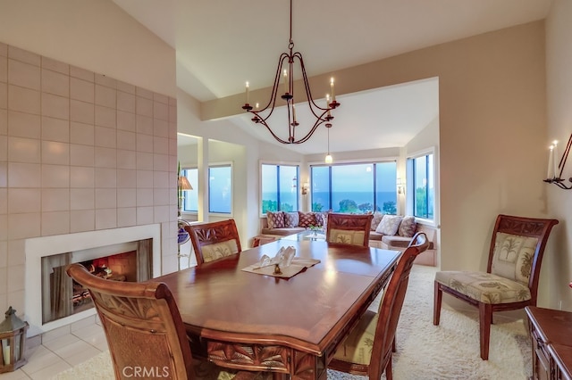 2209 W 25th St Unit 2, San Pedro, CA 90732 - dining space featuring vaulted ceiling, a chandelier, a large fireplace, and light tile patterned flooring