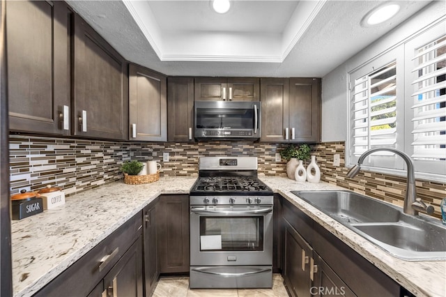 1665 Bridgeport, West Covina, CA 91791 - kitchen with appliances with stainless steel finishes, dark brown cabinets, tasteful backsplash, and a raised ceiling