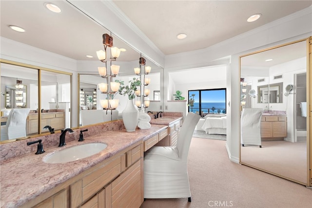 408 Pasadena Ct Unit L, San Clemente, CA 92672 - ensuite bathroom featuring double vanity, a chandelier, crown molding, and recessed lighting
