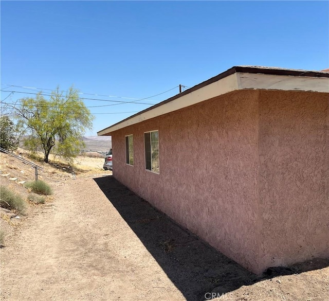 255 W Grace St, Barstow, CA 92311 - view of side of home with stucco siding