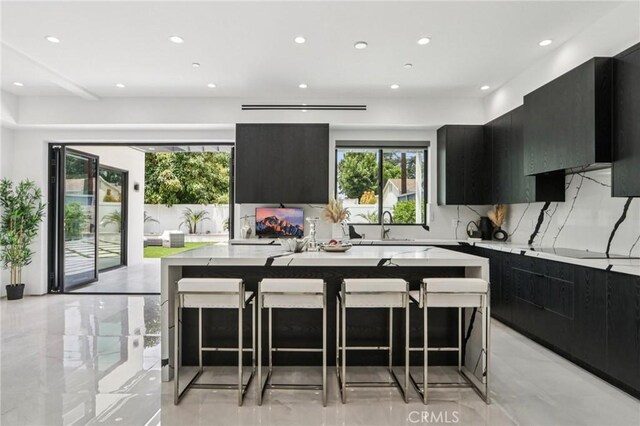2227 N Lamer St, Burbank, CA 91504 - kitchen featuring dark cabinets, modern cabinets, a spacious island, recessed lighting, and tasteful backsplash