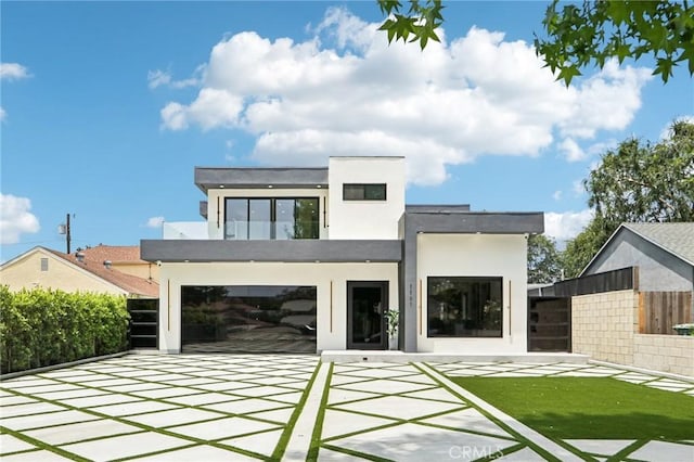 2227 N Lamer St, Burbank, CA 91504 - rear view of property with stucco siding, a patio, and a garage