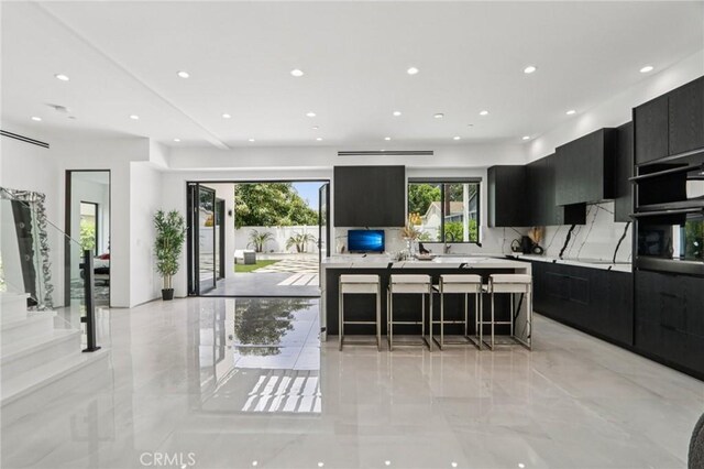 2227 N Lamer St, Burbank, CA 91504 - kitchen with dark cabinets, modern cabinets, light countertops, backsplash, and recessed lighting