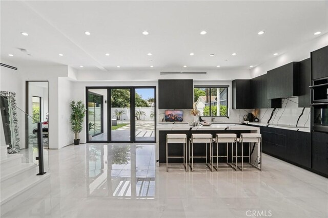 2227 N Lamer St, Burbank, CA 91504 - kitchen featuring dark cabinets, a kitchen island, modern cabinets, recessed lighting, and light countertops