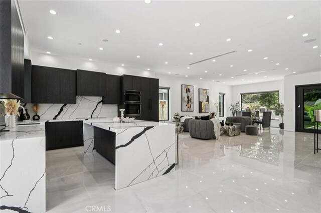 2227 N Lamer St, Burbank, CA 91504 - kitchen with modern cabinets, dark cabinetry, recessed lighting, decorative backsplash, and light marble finish flooring