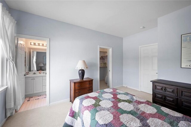 3262 Bluebird Cir, Simi Valley, CA 93063 - bedroom featuring light carpet, baseboards, ensuite bathroom, and a walk in closet