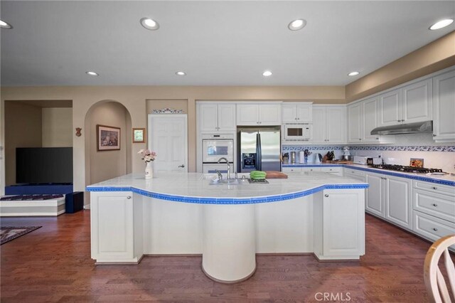 3262 Bluebird Cir, Simi Valley, CA 93063 - kitchen with appliances with stainless steel finishes, light countertops, white cabinets, a large island, and recessed lighting