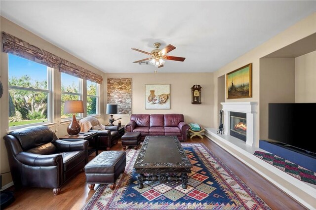 3262 Bluebird Cir, Simi Valley, CA 93063 - living area featuring ceiling fan, a glass covered fireplace, and wood finished floors