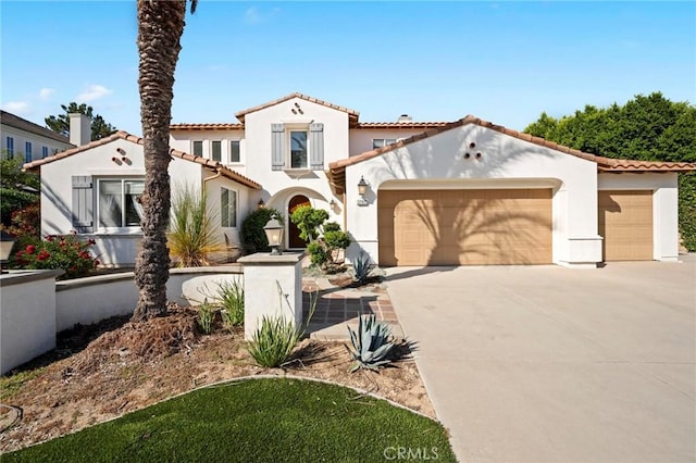 3262 Bluebird Cir, Simi Valley, CA 93063 - mediterranean / spanish-style house with a garage, concrete driveway, stucco siding, and a tiled roof