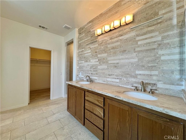 345 W Saint Andrews St, Ontario, CA 91762 - bathroom with a walk in closet, double vanity, and tile patterned flooring