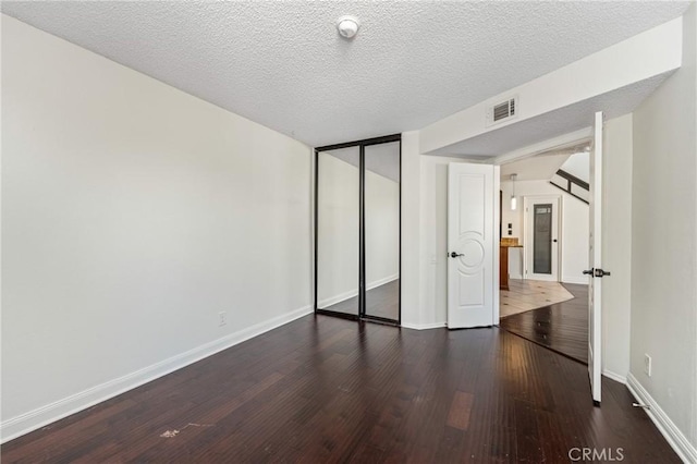 13115 Le Parc Unit 40, Chino Hills, CA 91709 - unfurnished bedroom with wood finished floors, baseboards, a closet, and a textured ceiling