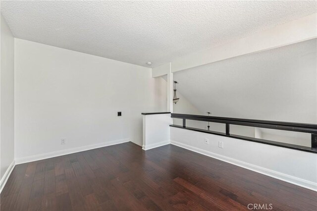 13115 Le Parc Unit 40, Chino Hills, CA 91709 - spare room with wood finished floors, a textured ceiling, baseboards, and vaulted ceiling