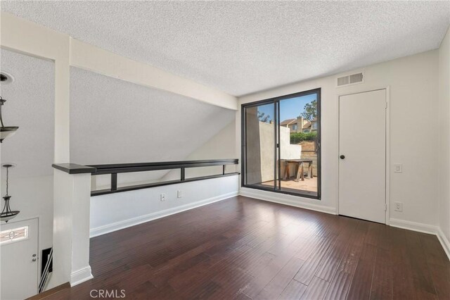 13115 Le Parc Unit 40, Chino Hills, CA 91709 - unfurnished room featuring a textured ceiling, wood finished floors, baseboards, and vaulted ceiling