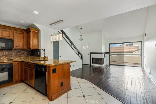 13115 Le Parc Unit 40, Chino Hills, CA 91709 - kitchen with black appliances, brown cabinetry, a sink, tasteful backsplash, and light tile patterned floors