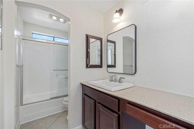 13115 Le Parc Unit 40, Chino Hills, CA 91709 - full bath featuring toilet, vanity, tile patterned floors, and combined bath / shower with glass door