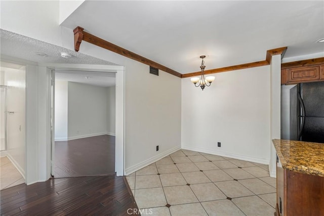 13115 Le Parc Unit 40, Chino Hills, CA 91709 - unfurnished dining area featuring a chandelier, baseboards, and light wood-style floors