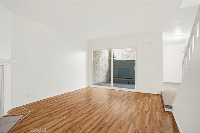 18411 Hatteras St Unit 122, Tarzana, CA 91356 - unfurnished living room featuring light wood finished floors and baseboards