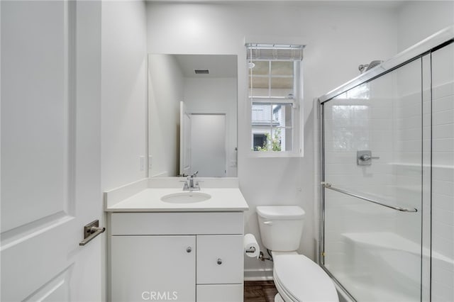 7452 Desert Holly St, Chino, CA 91708 - bathroom with toilet, vanity, a stall shower, and baseboards