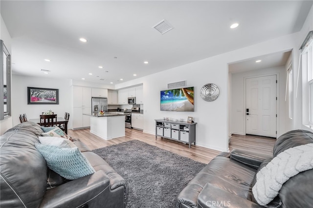 7452 Desert Holly St, Chino, CA 91708 - living room with recessed lighting and light wood-type flooring