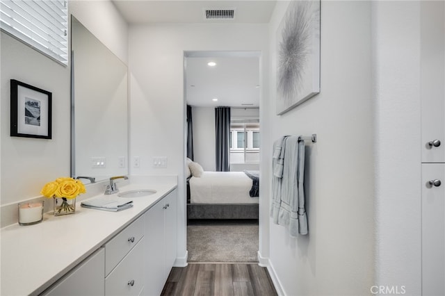 7452 Desert Holly St, Chino, CA 91708 - ensuite bathroom featuring wood finished floors and vanity