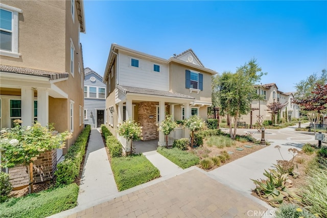 7452 Desert Holly St, Chino, CA 91708 - view of property featuring stucco siding, a residential view, and covered porch