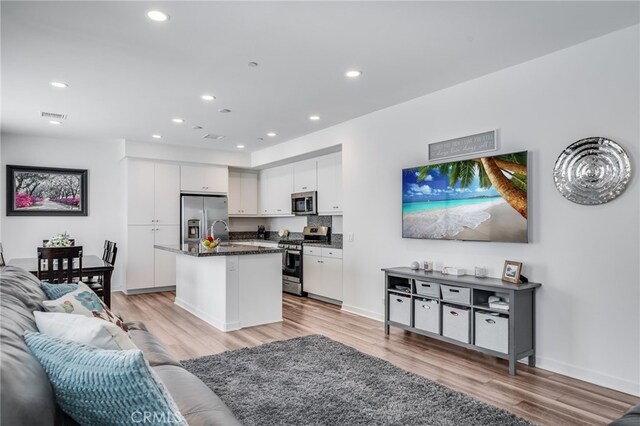 7452 Desert Holly St, Chino, CA 91708 - living room with light wood-style flooring and recessed lighting