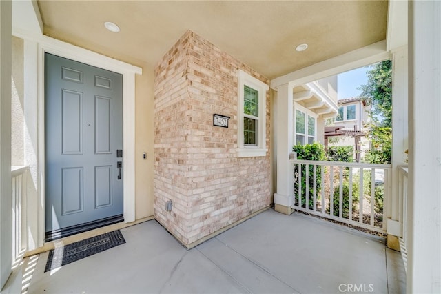 7452 Desert Holly St, Chino, CA 91708 - view of exterior entry featuring brick siding and a porch