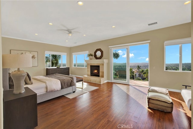 3313 Cabo Ct, Carlsbad, CA 92009 - bedroom with access to outside, multiple windows, wood finished floors, ornamental molding, and a tile fireplace