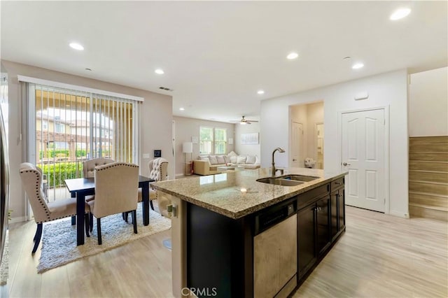 6045 Lyon St, Chino, CA 91710 - kitchen with dishwashing machine, light wood-style floors, an island with sink, light stone counters, and recessed lighting