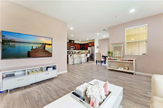 6045 Lyon St, Chino, CA 91710 - living area featuring light wood finished floors and recessed lighting