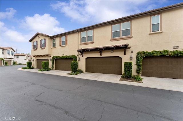 6045 Lyon St, Chino, CA 91710 - view of front of home featuring an attached garage, stucco siding, and a tile roof