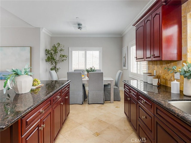 229 N Juanita Ave Unit B, Redondo Beach, CA 90277 - kitchen with dark brown cabinets, tasteful backsplash, ornamental molding, and dark stone countertops