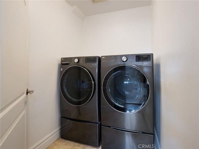 229 N Juanita Ave Unit B, Redondo Beach, CA 90277 - laundry area featuring washing machine and dryer, baseboards, and light tile patterned flooring