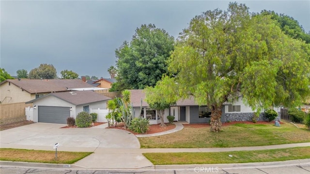 6367 Willow Ave, Rialto, CA 92377 - ranch-style house with concrete driveway, an attached garage, and stucco siding