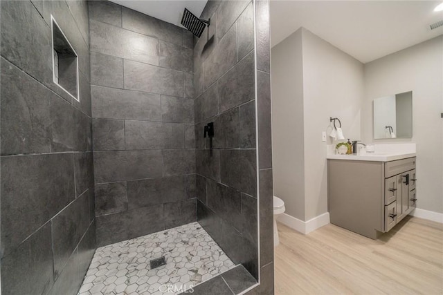 6367 Willow Ave, Rialto, CA 92377 - full bathroom featuring wood finished floors, vanity, and tiled shower